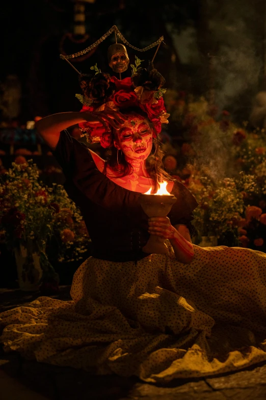 a woman is holding a lit candle in front of a dog