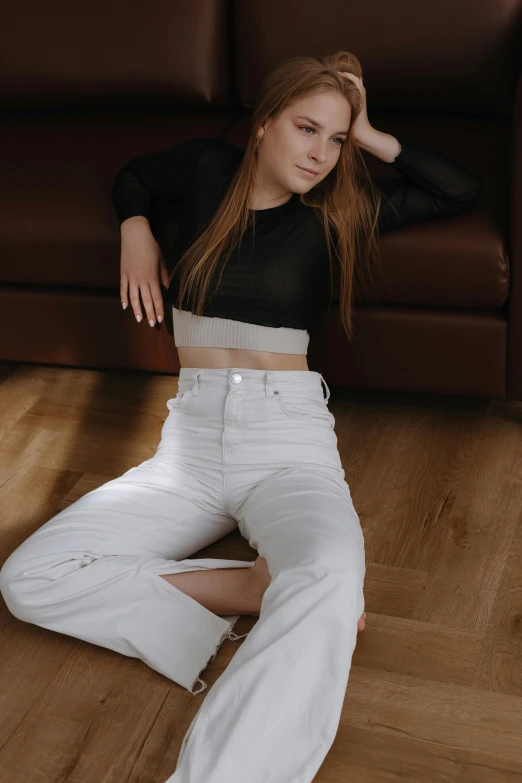 a woman sitting on the floor with her legs crossed