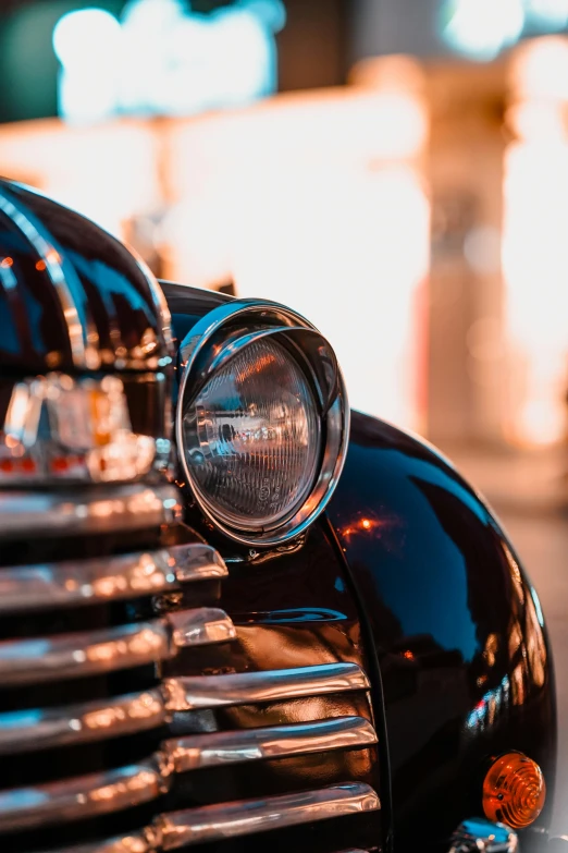 an old fashioned car with its headlight showing