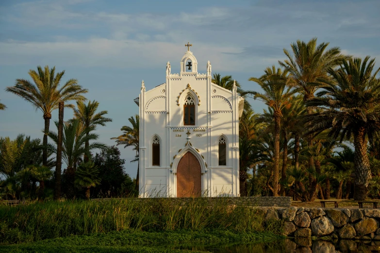 the small church is located by the tropical vegetation