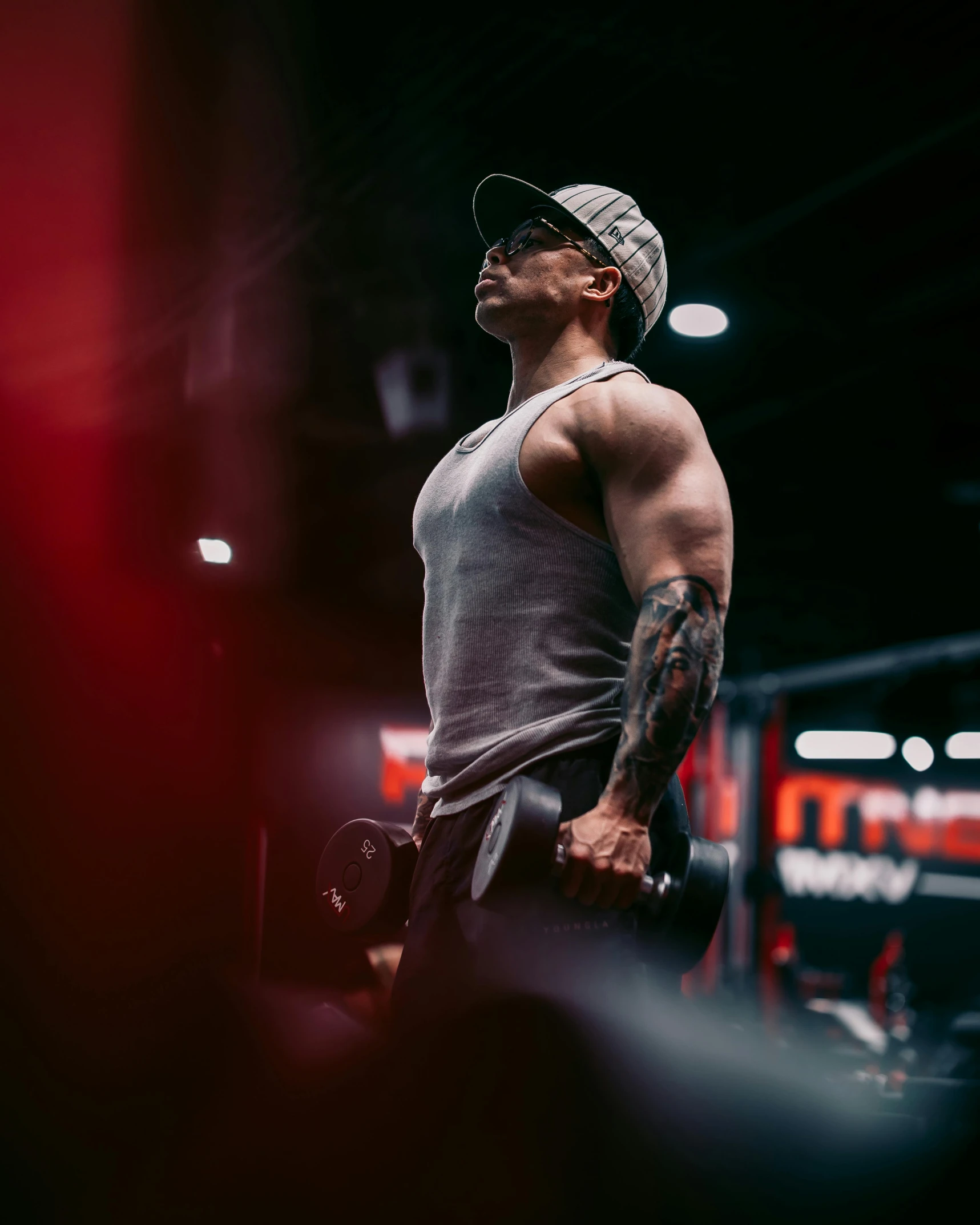 man in white shirt with a tattoo on his arm