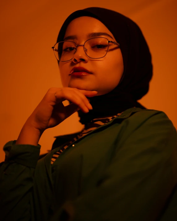 woman in hijab, dark glasses, and necklace