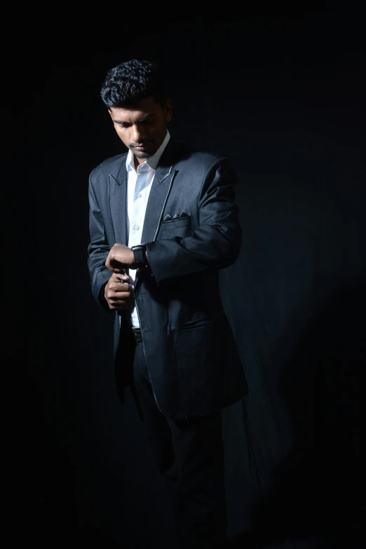 a man in suit posing for a po