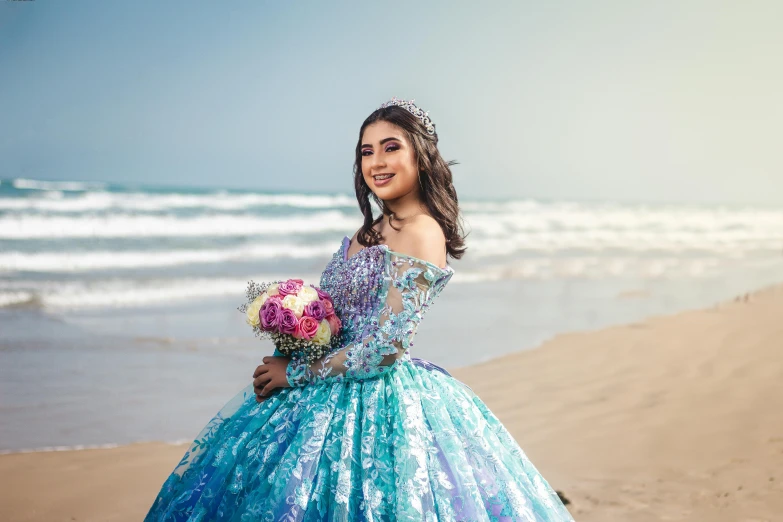 a girl wearing a mermaid costume on a beach