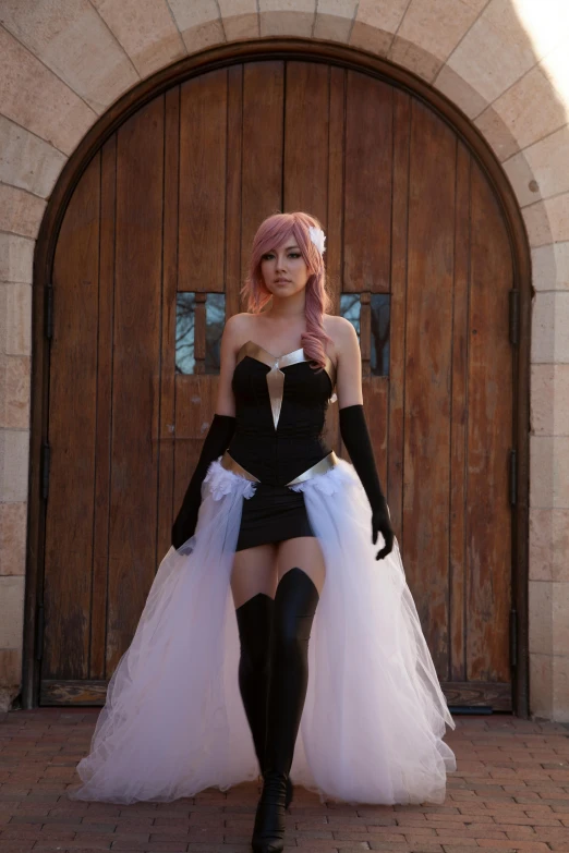 a woman in an adorable corset poses outside a garage door