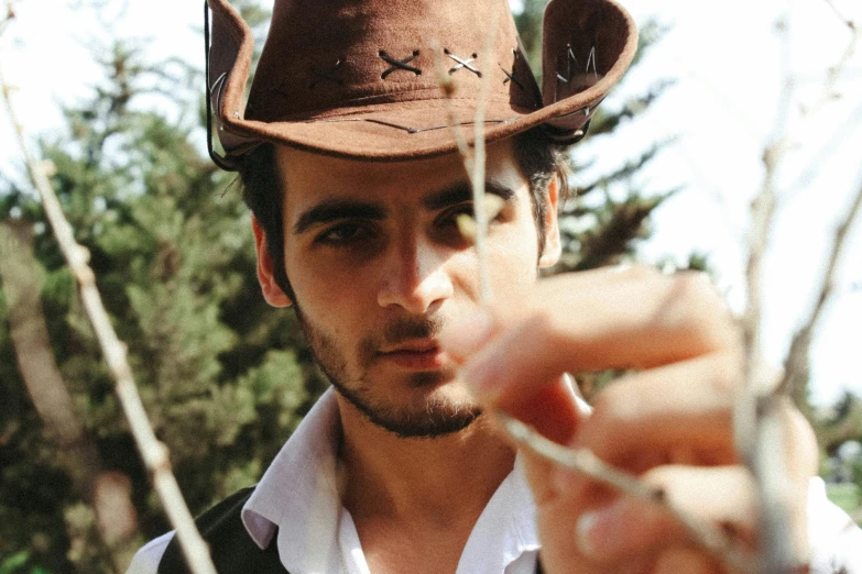 a man is dressed in an old western hat