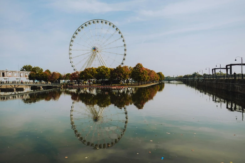 a ferris wheel is shown on the river bank