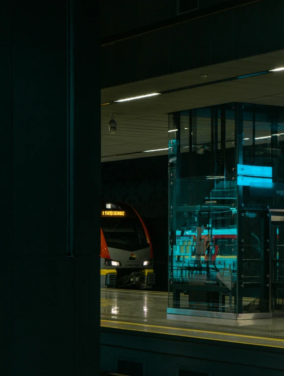 a train sitting in the train station next to another train