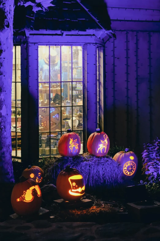 some pumpkins are glowing in purple light