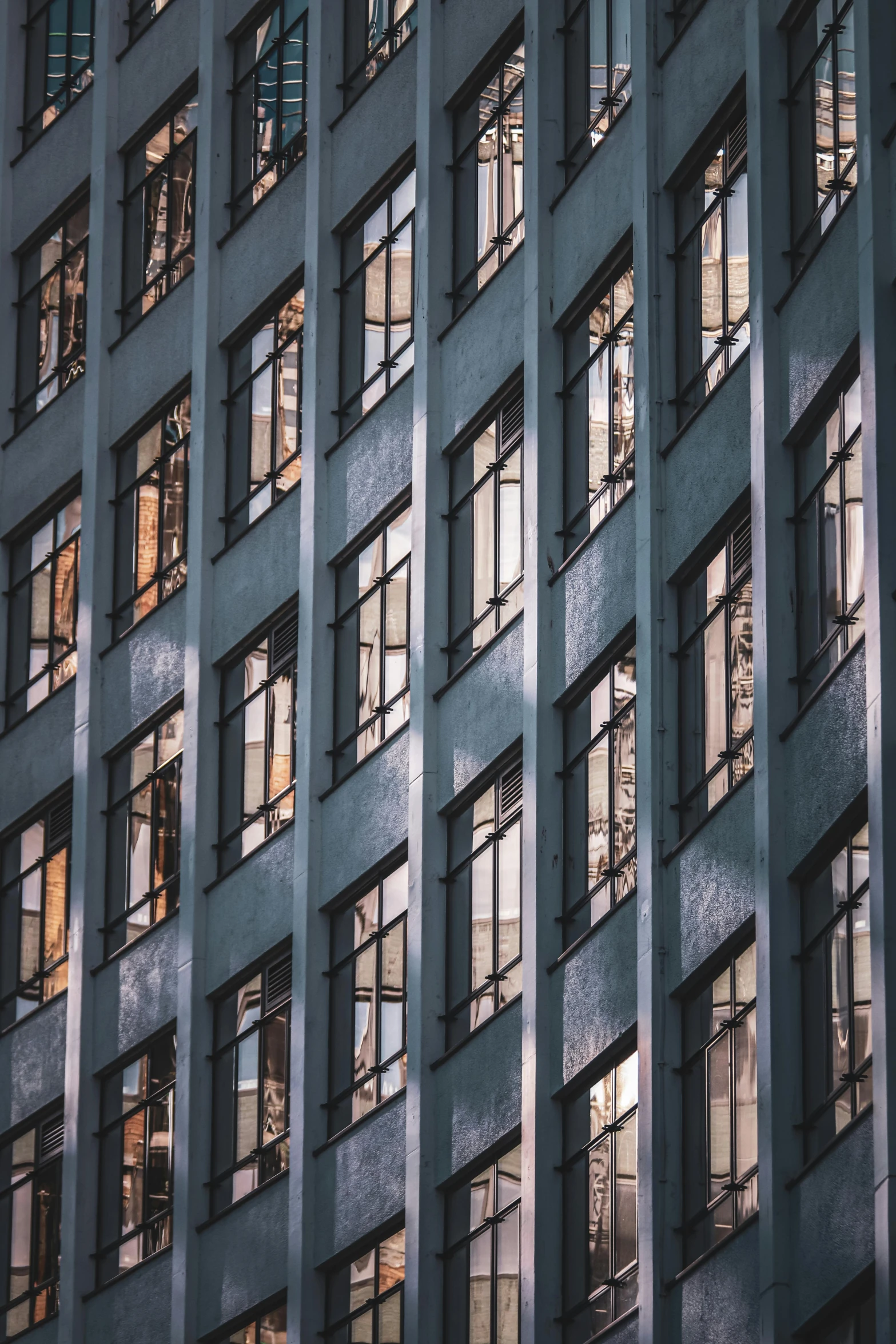 tall building with lots of windows that is all reflecting in it