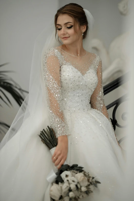 a bride with a veil and veillet, holding a bouquet