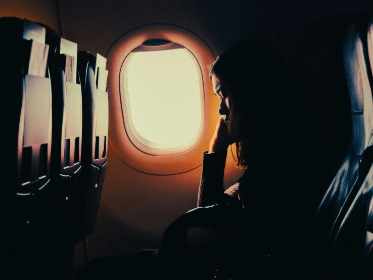 a window looking into an airplane while sitting in a chair