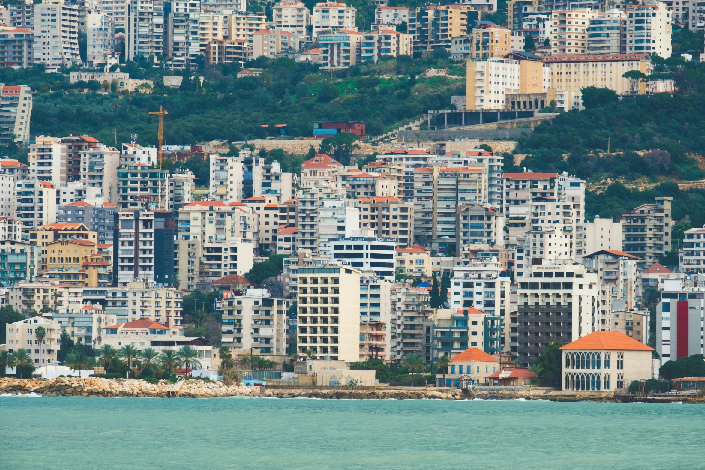 an overview view of many buildings by the ocean