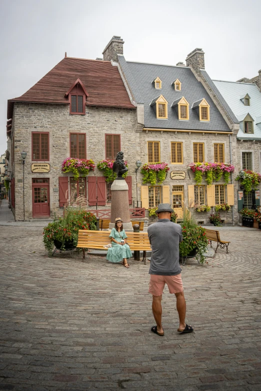 a man that is standing in the dirt near flowers