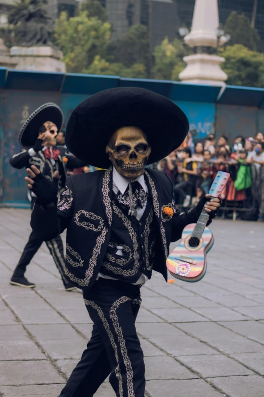 a man in skeleton suit with an guitar on his hand