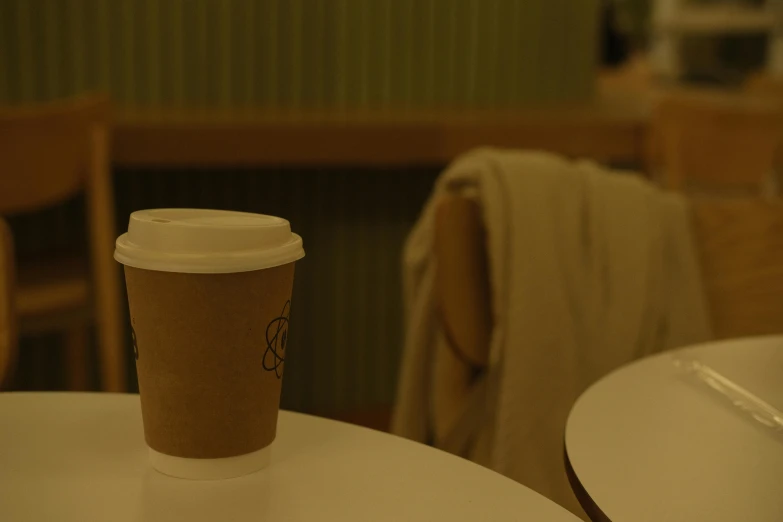 a paper cup sitting on top of a table