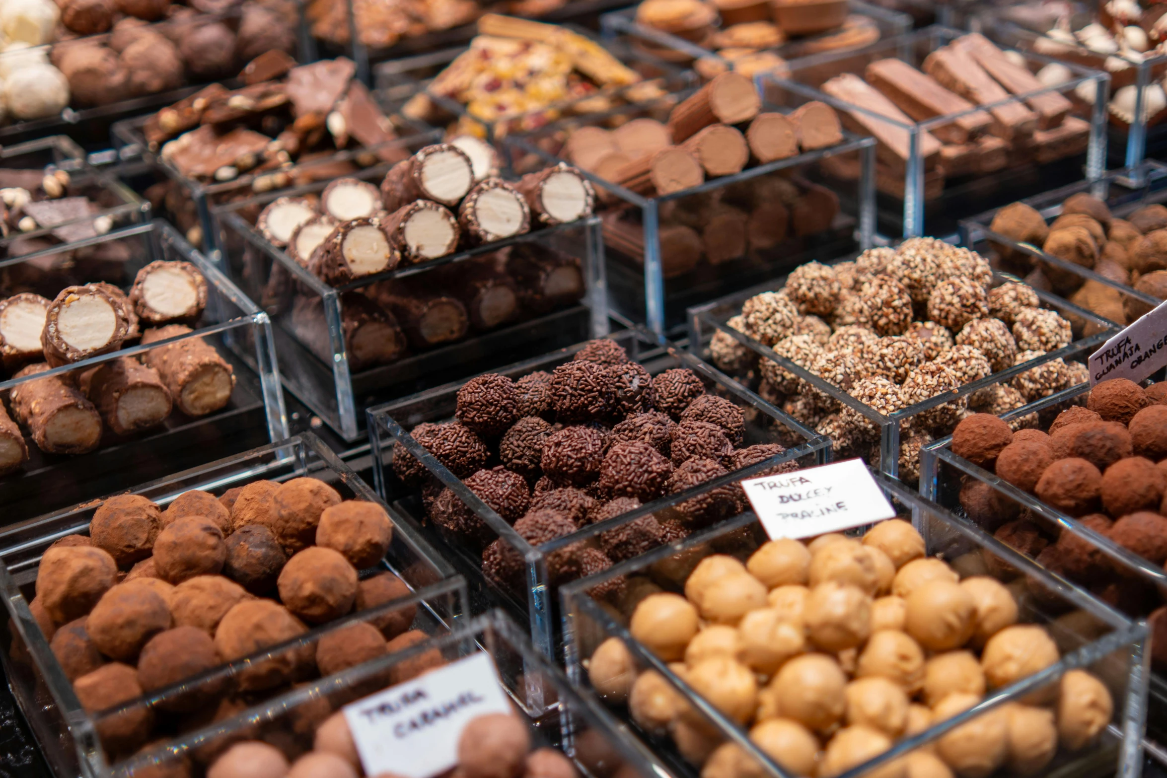 a display case of chocolates with different kinds