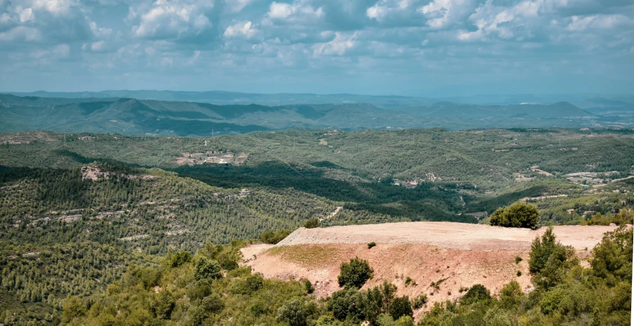 a view of hills and trees and the sky