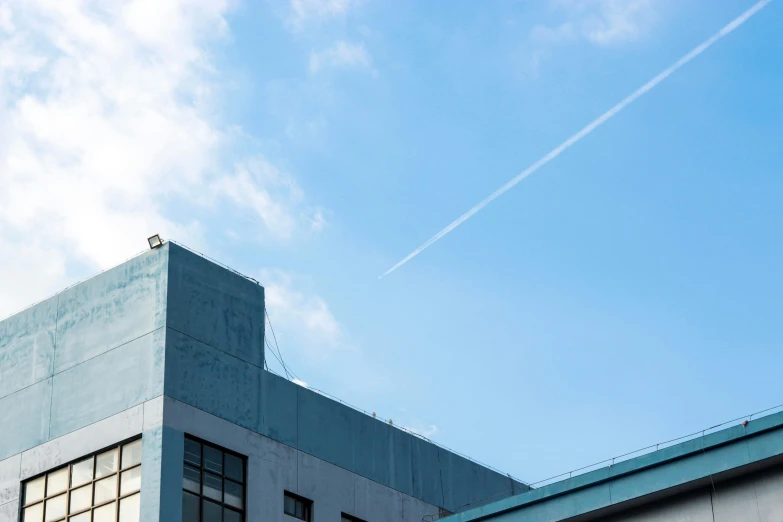 a plane is flying over a tall building