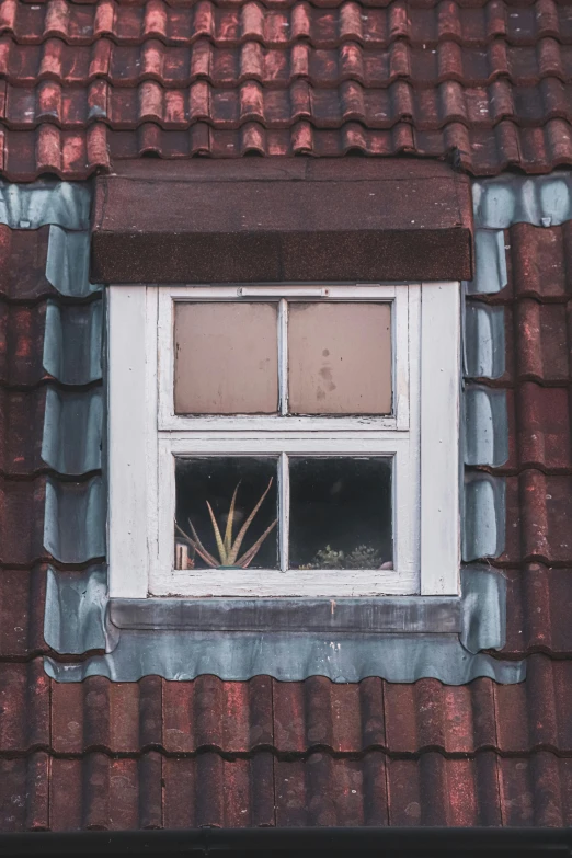 small window with white frame with red roof