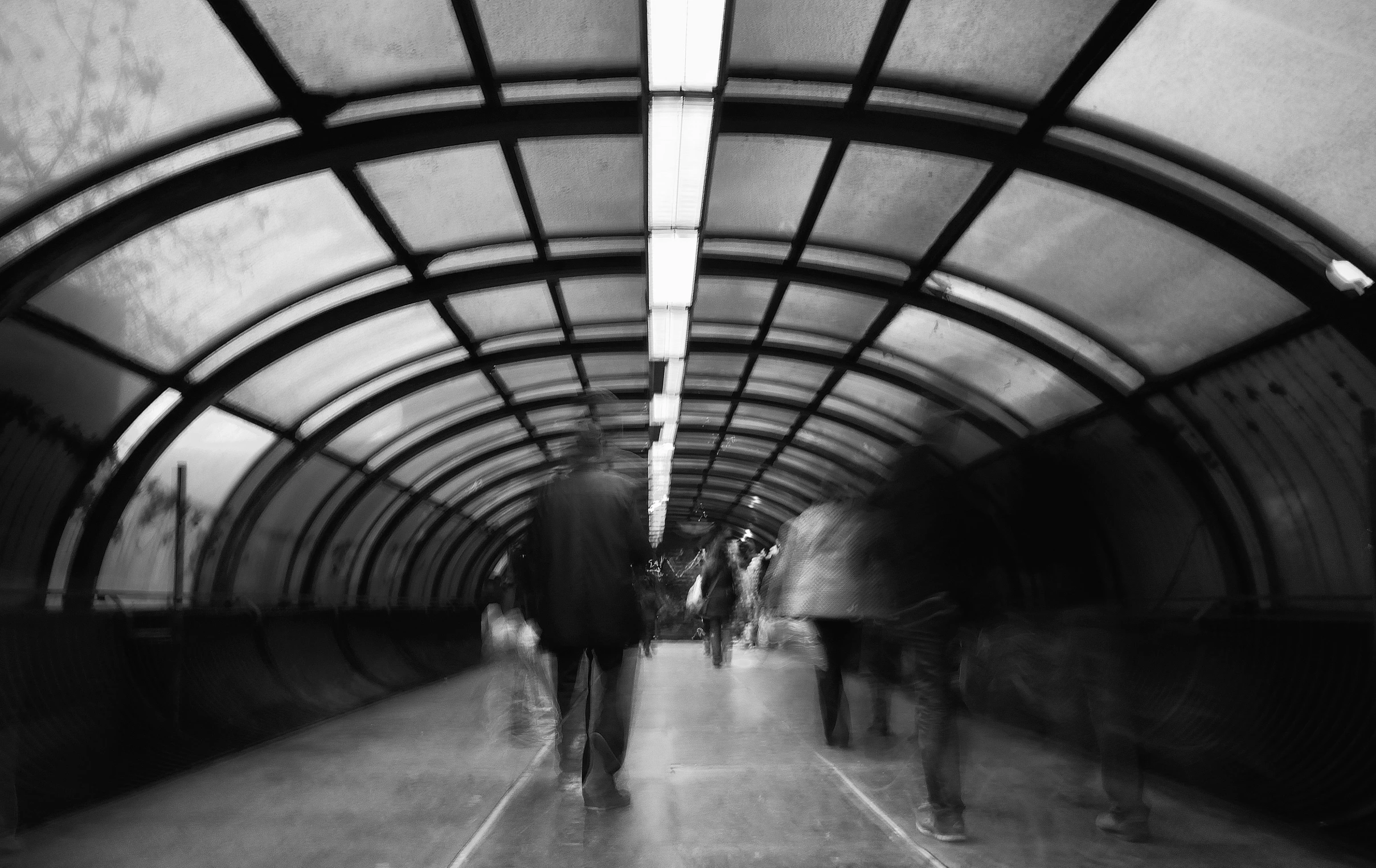 people are standing together inside of a tunnel