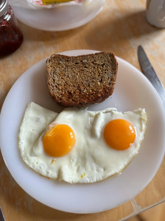 an egg and some bread sitting on a plate