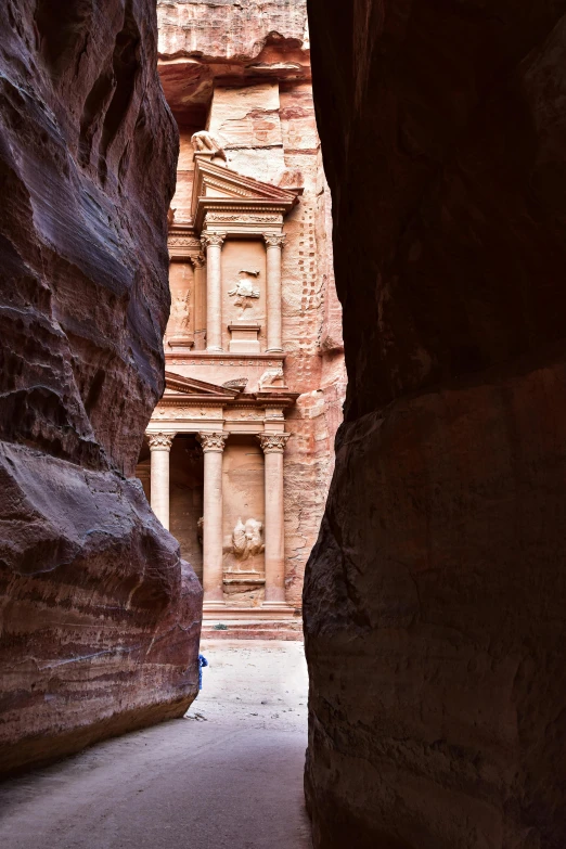 an alley that is very narrow and has a building built into the side