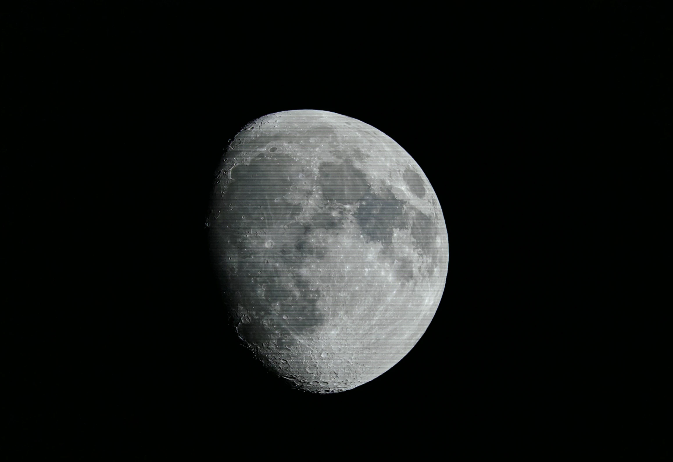 a moon is seen with a black background