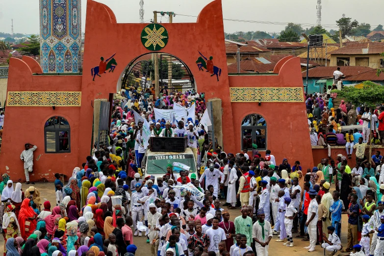 people gather in front of an open building