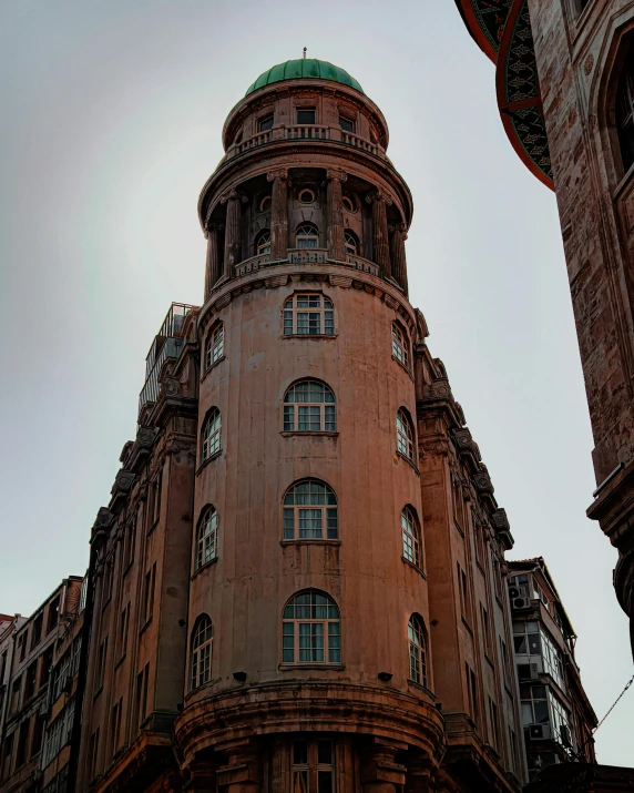 a tall building sitting next to a tall clock tower