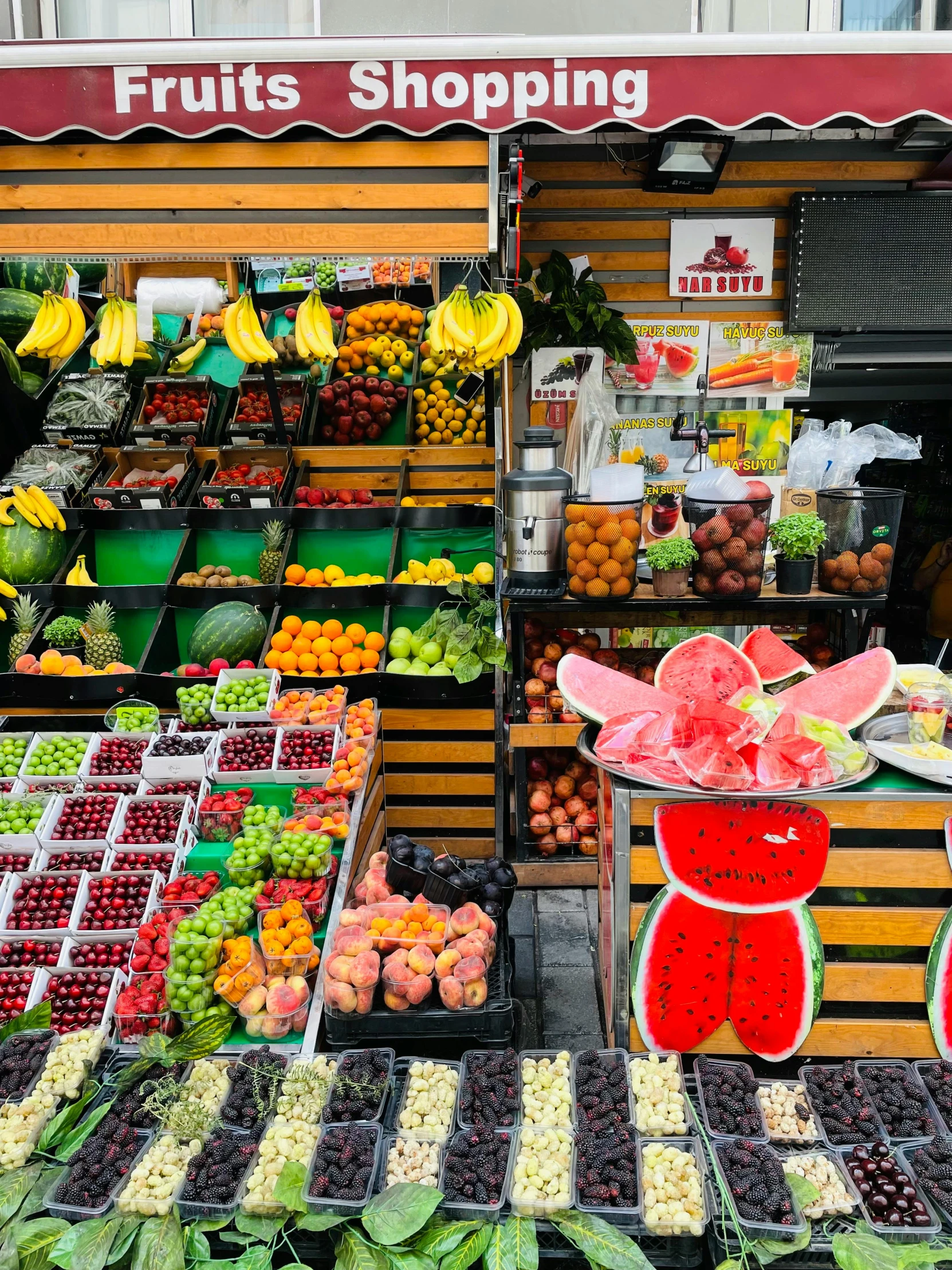 a fruit stand is shown with fruits and vegetables