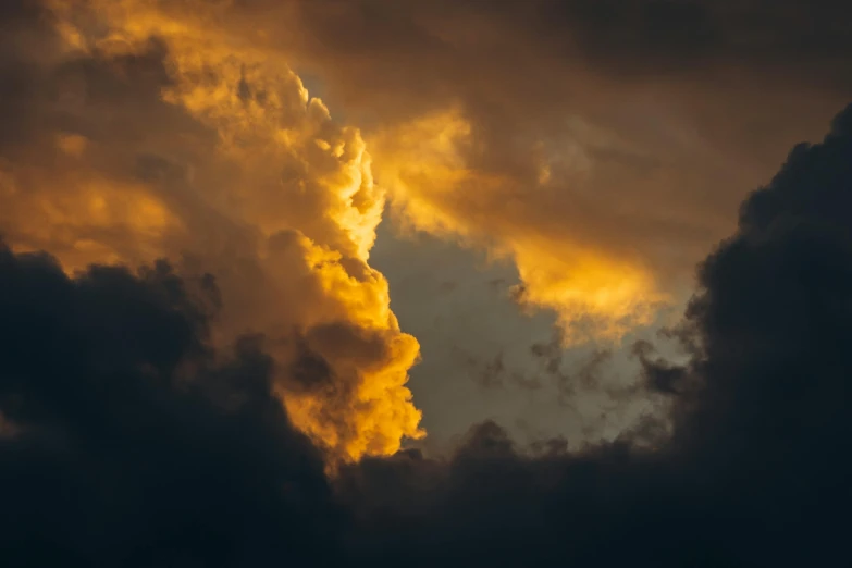 a jet flying past some dark clouds in the sky