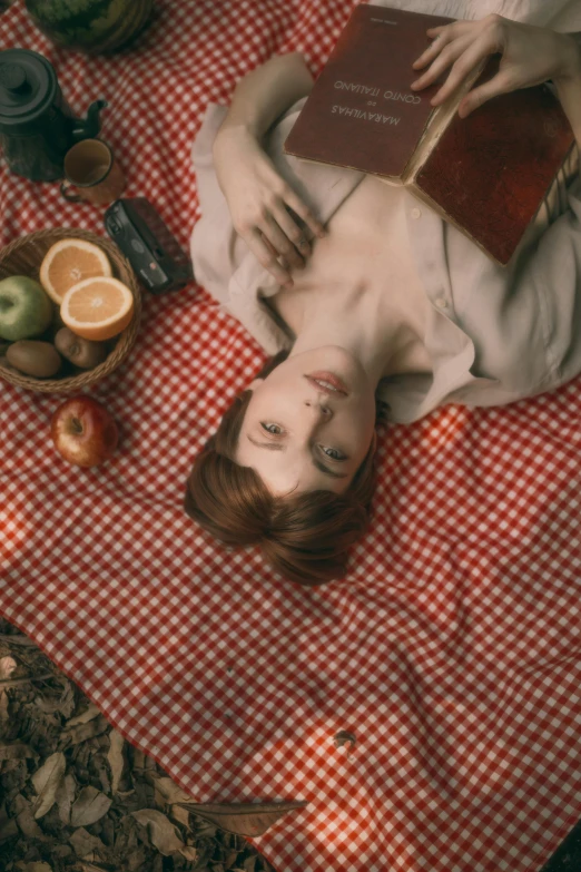 a woman laying on a table with food and other items