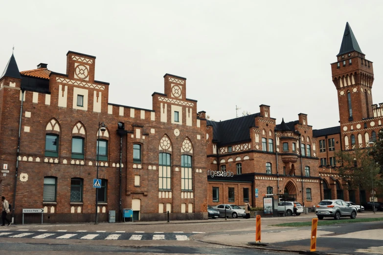 a large brown brick building with a clock tower