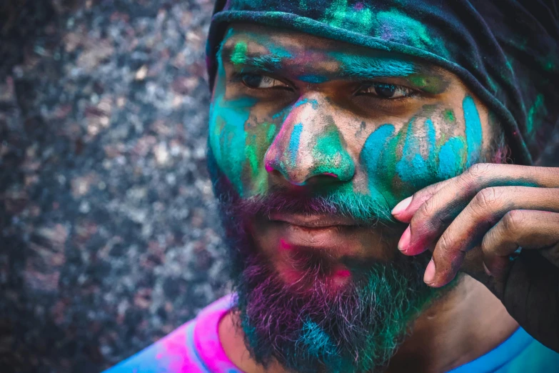 a bearded man wearing turban and colorful face paint