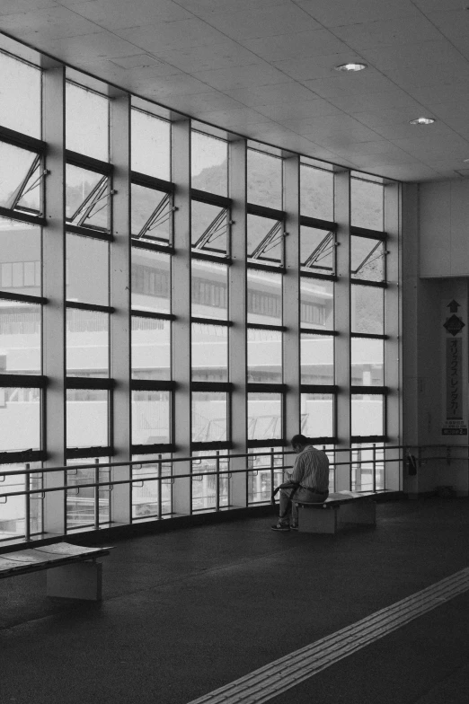 a person sitting on a bench at an airport