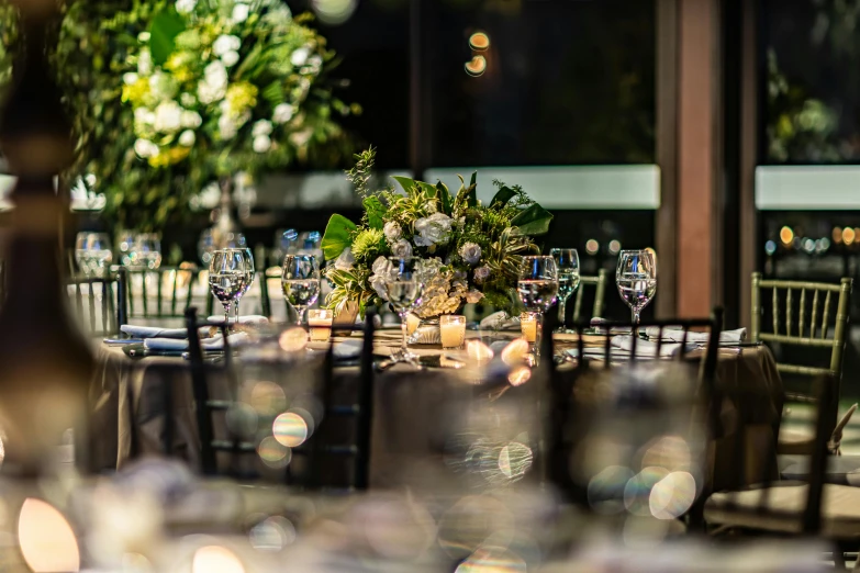 an outdoor dinner event has tall wooden chairs