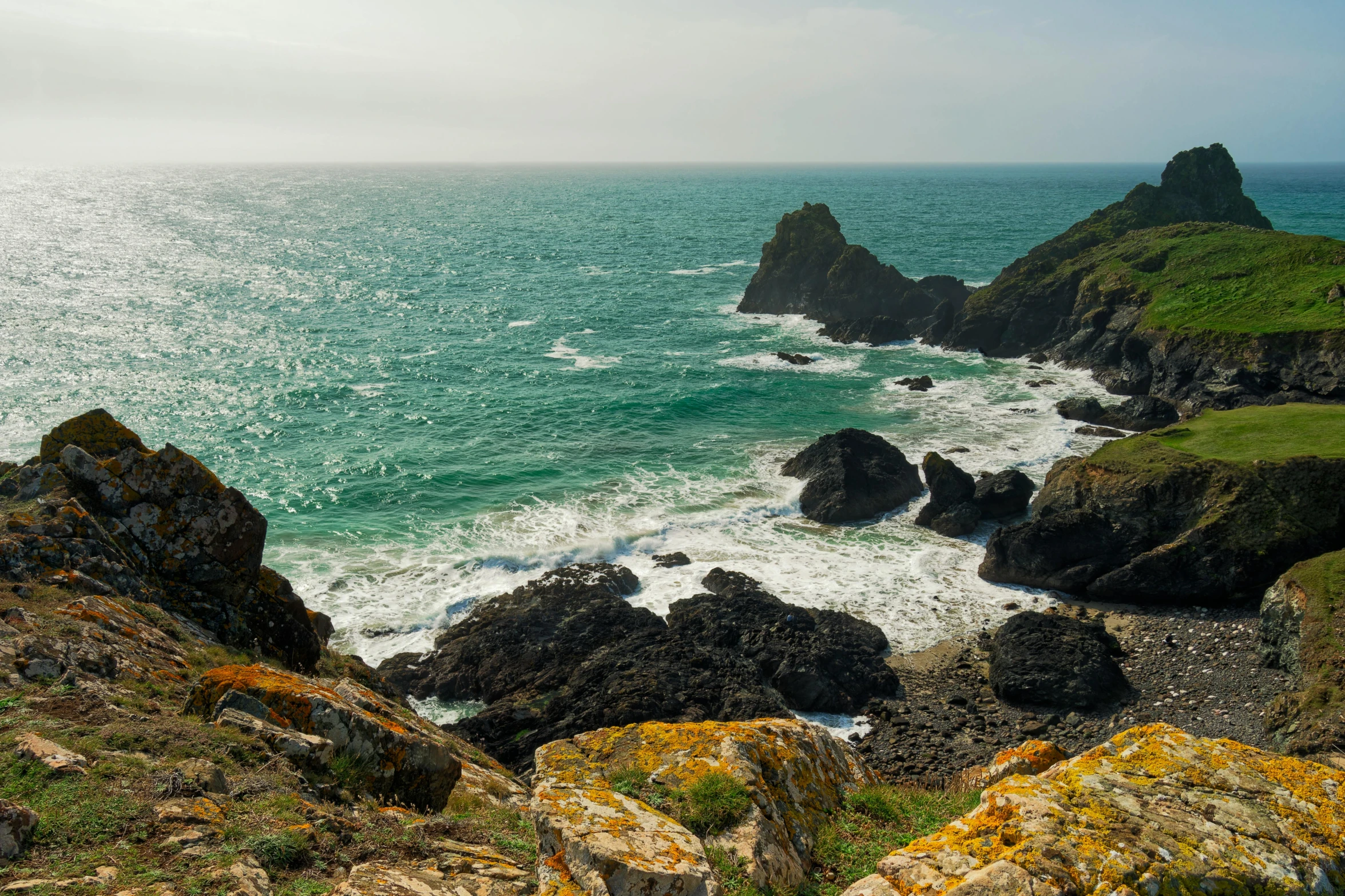 ocean rocky shore with sea in background during daytime