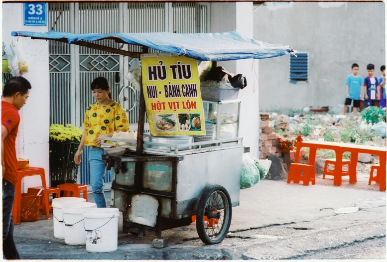 a vendor sells food to the patrons of his shop