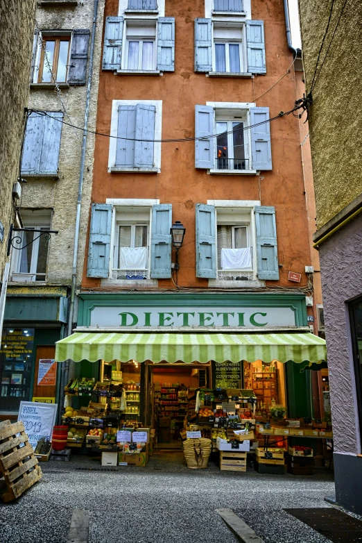 a building with a green awning sitting next to each other