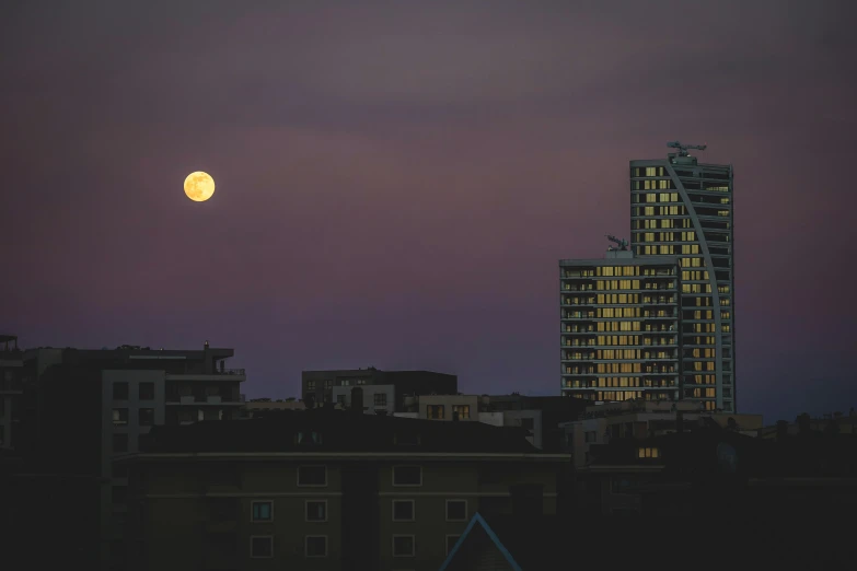 a tower at night with the moon in the background