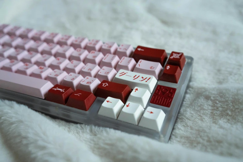 a computer keyboard with a pink and white keyboard top