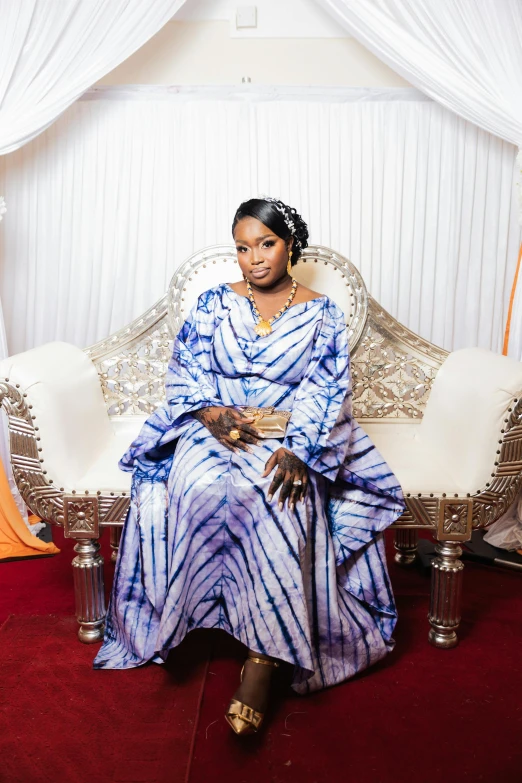 an african american woman in a purple striped dress