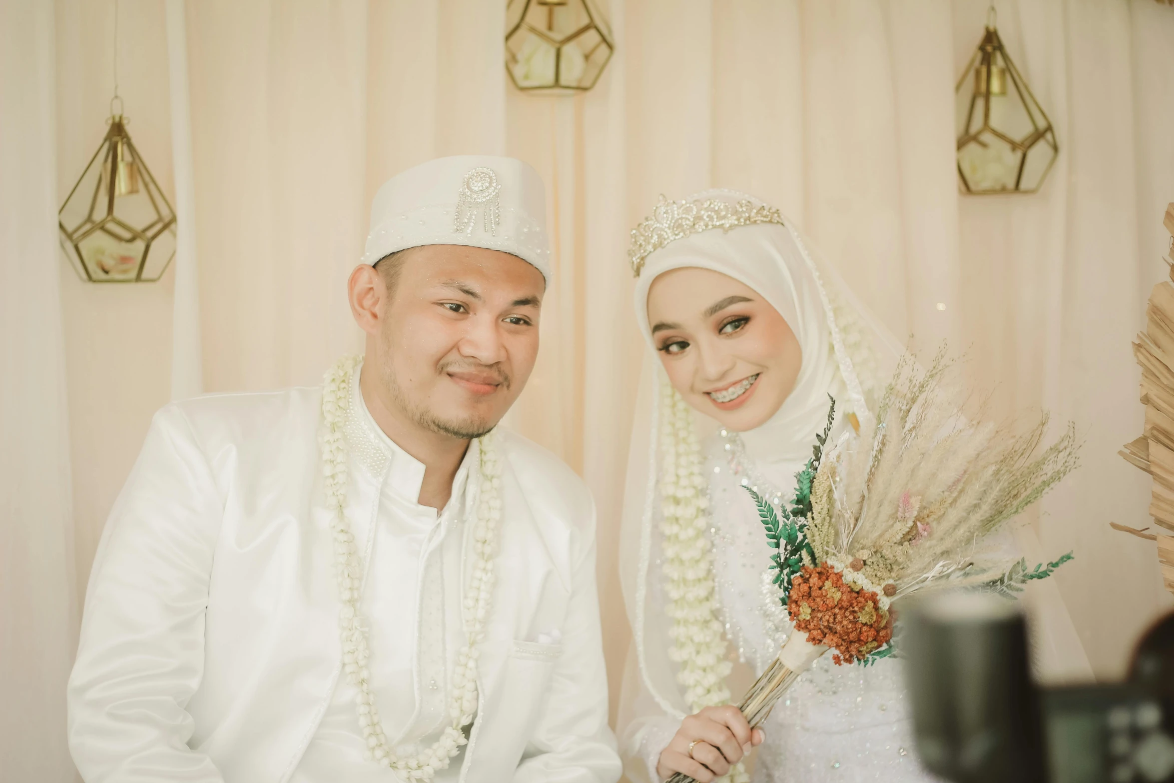 two people dressed in white standing near each other