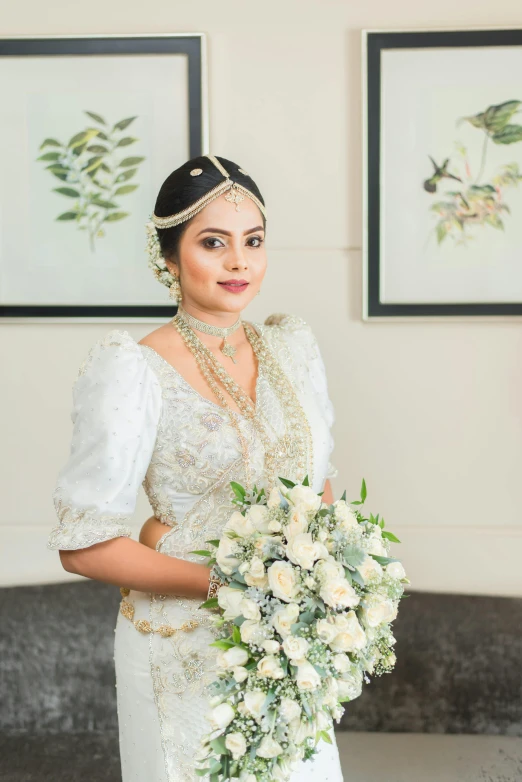 a woman in a bridal gown holding a flower bouquet