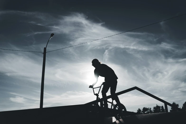 a man riding his bike up the top of stairs