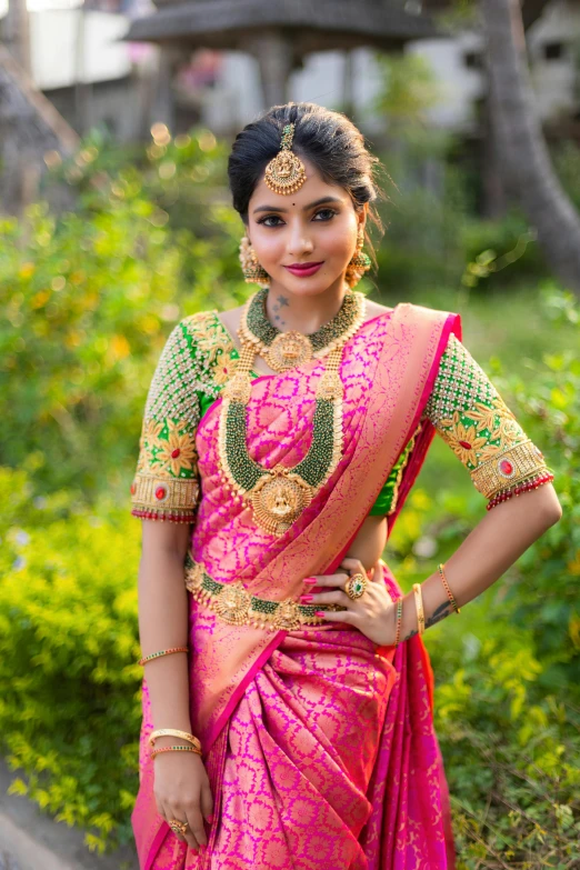 a beautiful indian woman in a pink sari