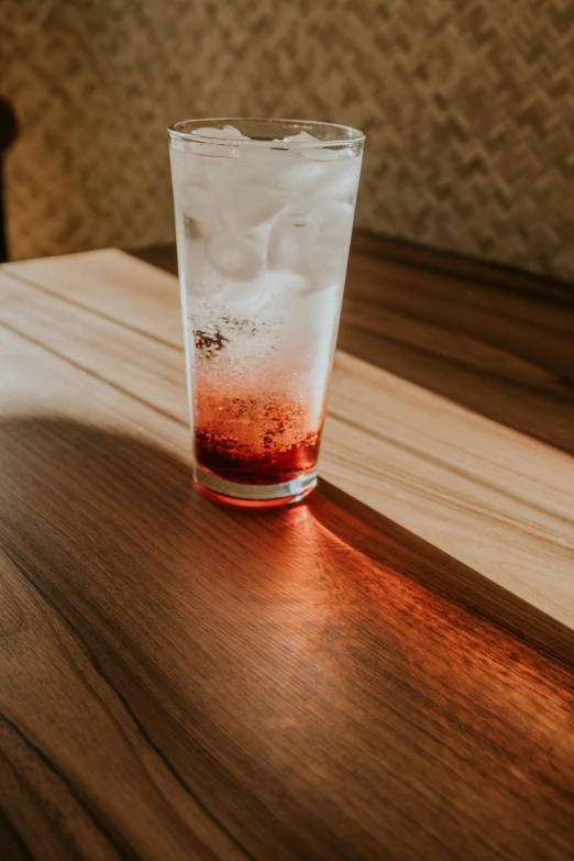 a red liquid in a glass on a table