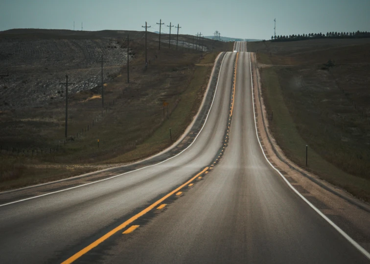 a wide highway with several lanes and lights