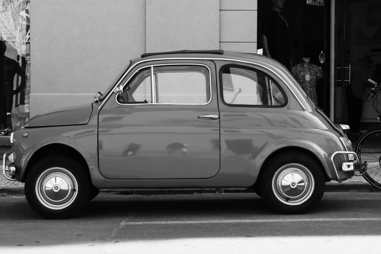 an old fashioned car parked on a city street